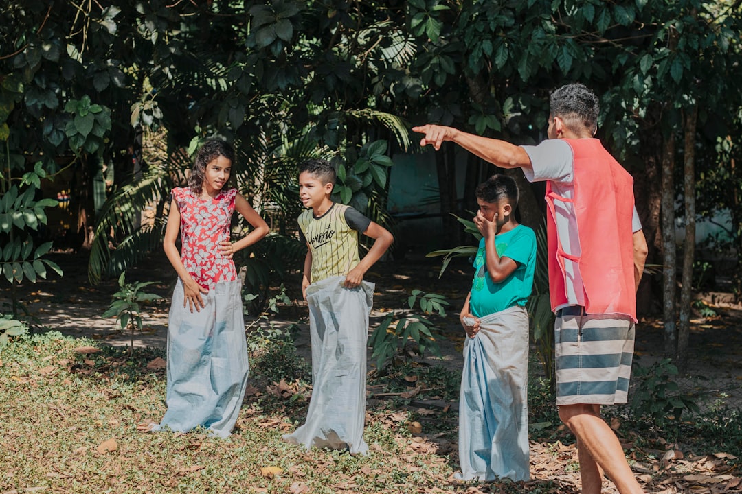 Active grandfather enjoying time with grandchildren showing functional fitness
