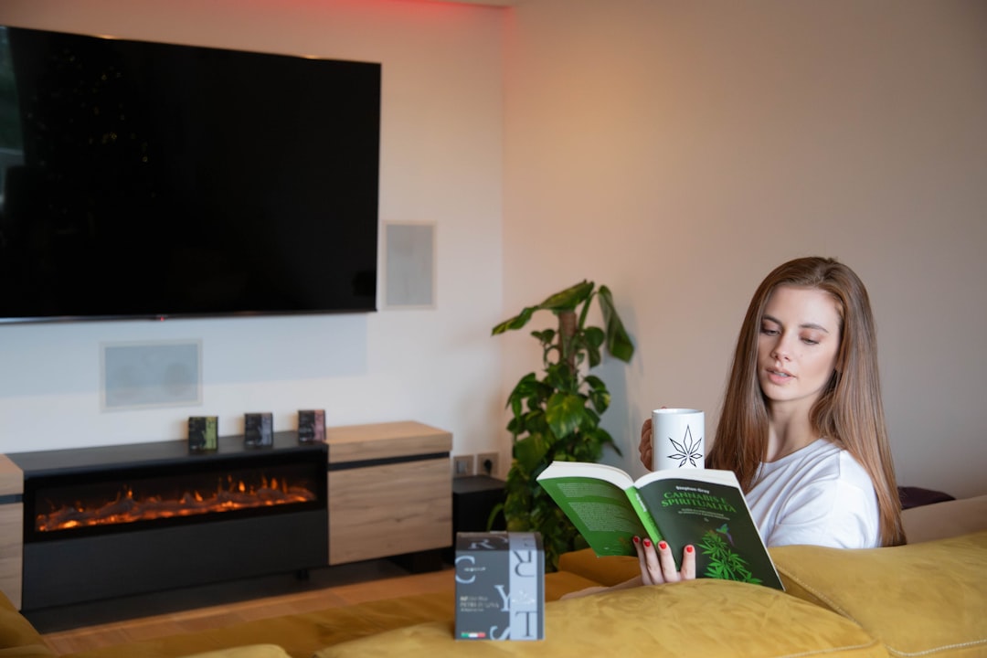 Person relaxing with wellness reading materials in a bright, cozy home setting